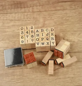 Detailed view of 40 pieces wooden stamps set with typewriter font and black ink pad