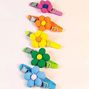 Five colorful pet collars with plush corduroy flower decorations and adjustable buckles