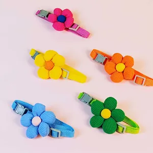 Detail view of colorful adjustable pet collars with cute corduroy flower decors.