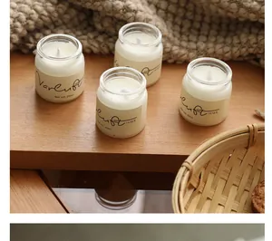 Close-up of four small scented candles in glass jars with 20ml volume labels