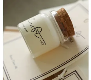 Close-up of a 20ml scented candle sample with a cork lid and label details