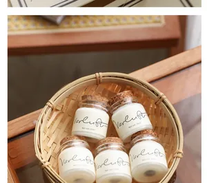 Close-up of five mini 20ml scented candle samples with cork lids in a bamboo basket