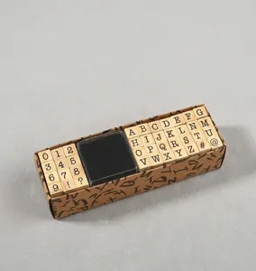Detailed view of 40-piece wooden alphabet and number stamp set with ink pad