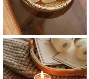 Close-up of small travel scented candle with lit flame in a natural bamboo basket