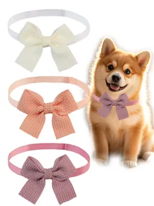 Detail view of waffle textured pet bow tie collars in various solid colors shown on a dog