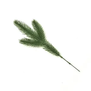 Top view of a realistic three-pronged artificial green pine needle branch detail