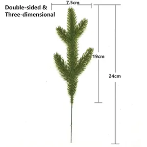 Macro detail view of artificial pine branch with dimension markings 24cm total length