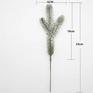 Macro detail of artificial snowy pine needle branch for Christmas wreath decoration