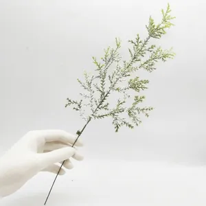 Detailed macro view of a frosted PE pine needle branch for DIY Christmas wreaths