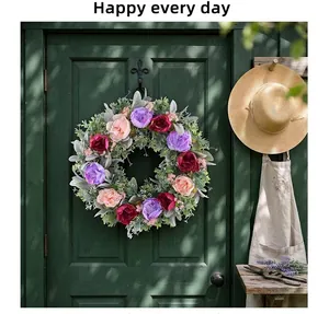 Detailed view of artificial peony flower wreath on green wooden door for rustic home decor