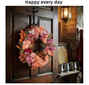 Dettaglio della ghirlanda autunnale di ortensie e rose su una porta di legno d'epoca.