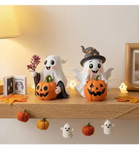Detailed shot of cute resin ghost and pumpkin ornaments for cozy Halloween home decor