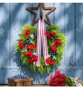 Detailed view of American style wreath with red hydrangea and blueberries on blue door