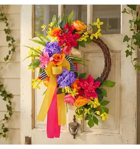 Vibrant spring summer grapevine floral wreath with colorful roses hanging on a vintage door