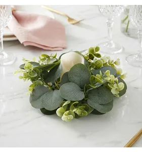 Close-up of artificial eucalyptus leaf wreath candle holder for festive table decor