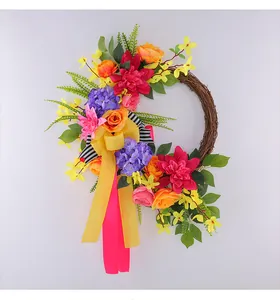 Vibrant spring wreath with colorful artificial flowers, natural rattan, and yellow bow.