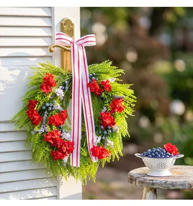 Close-up of a decorative front door wreath featuring red hydrangeas and blueberries