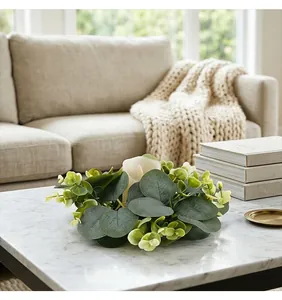 Faux eucalyptus wreath candle holder centerpiece on a white marble coffee table