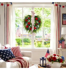 Detail view of American patriotic wreath with red flowers and striped ribbon on window