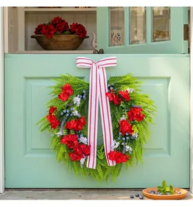 Detailed view of heart-shaped wreath featuring red hydrangeas, blueberries, and a striped bow.