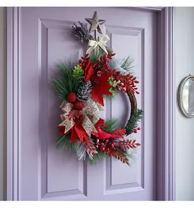 Detailed view of a Christmas wreath with red berries and pine on a purple door