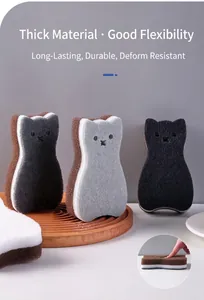 Detail of three-layer cat-shaped kitchen cleaning sponges with flexibility demonstration