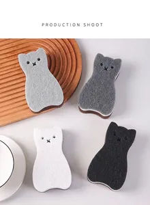 Macro detail of cat-shaped three-layer dishwashing sponges in neutral tones.