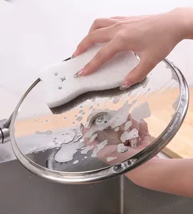 Close-up of cat-shaped three-layer kitchen cleaning sponge removing stains from glass