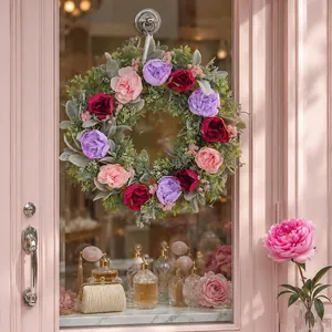 Vibrant tricolor peony flower wreath for spring door decoration hanging on a pink door
