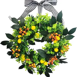 Ghirlanda di limoni e verde artificiale con fiocco a righe bianche e nere per porta