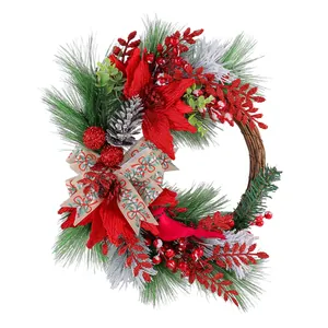 Christmas pine wreath with red berries, poinsettia, and cardinal bird for wall decoration.