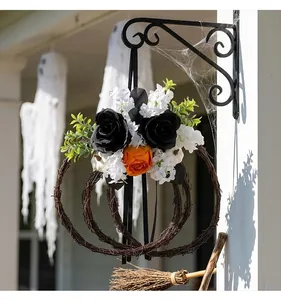 Detail of Halloween floral vine wreath featuring black roses, orange roses and white pumpkins
