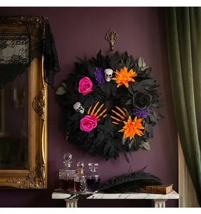 Gothic Halloween wreath with black leaves, skulls and colorful flowers detail shot