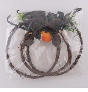 Halloween pumpkin floral wreath set shown inside clear plastic shipping bag packaging