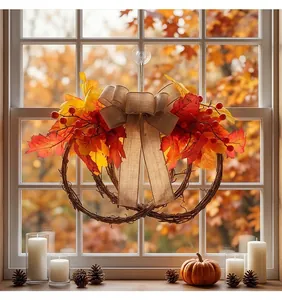 Detailed autumn wreath with maple leaves and berries hanging on a window for Thanksgiving