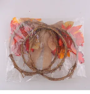 Detailed view of the autumn maple leaf berry rattan wreath in its plastic packaging.