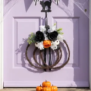 Decorative Halloween pumpkin wreath with black roses hanging on a light purple door
