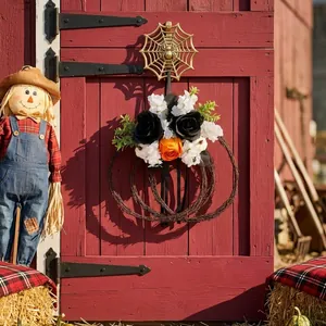 Handcrafted rustic pumpkin twig wreath with black and orange roses for Halloween decor