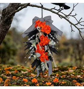 Detailed view of Halloween skeleton wreath with vibrant orange flowers and striped bow.