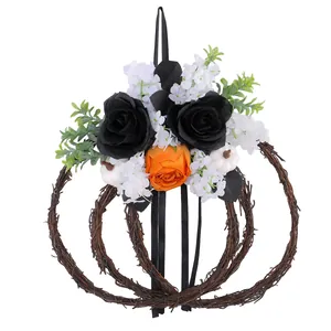 Decorative Halloween pumpkin grapevine wreath featuring black and orange artificial roses