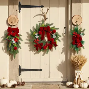 Festive Christmas wreath set with burgundy velvet bows and red berries on a rustic door.