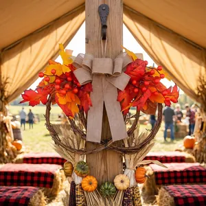 Autumn maple leaf wreath with red berries hanging on a rustic wooden post decoration