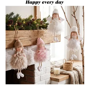 Close-up of Christmas angel doll ornaments with fluffy feathers in a warm home setting