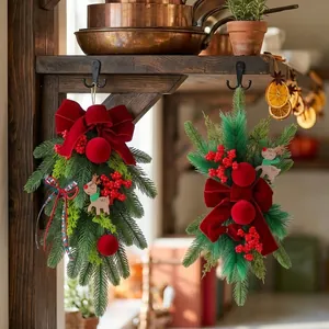 Christmas teardrop swag with burgundy velvet bow and red berries for festive door decor