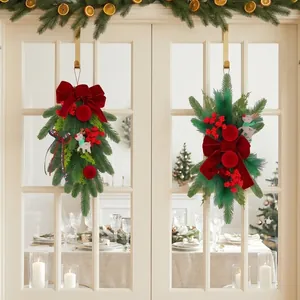 Festive burgundy flocked Christmas teardrop wreaths with red berries and velvet bows decor