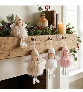 Set of 4 plush Christmas angel ornaments with soft feather skirts on a rustic mantle