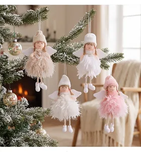 Macro view of four fluffy feather angel ornaments hanging on a snowy Christmas tree branch