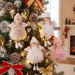 Plush Christmas angel hanging ornaments with feather skirts on a decorated holiday tree