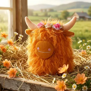 Peluche di mucca delle Highlands arancione con corona di fiori in un fienile rustico