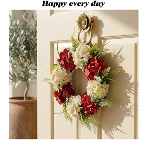 Decorative Christmas wreath featuring red and white hydrangeas hanging on an elegant door